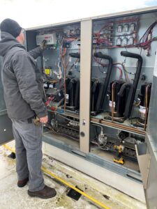 A man working on an electrical panel.